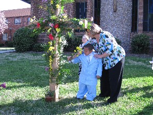 Each child want to be part of adding flowers to the cross