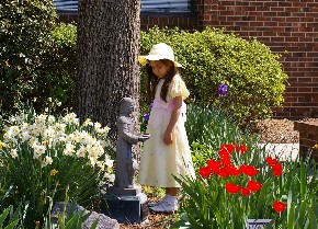 One child enjoying the flowers in the Memorial Garden